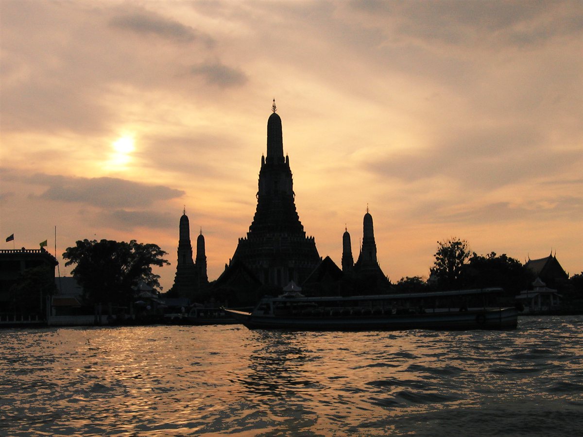 Silhueta do templo Wat Arun em Bangkok, Tailândia, ao entardecer, visto do rio Chao Phraya